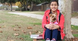 woman holding her dog Cesar's Way