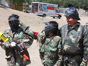 Cesar Millan bonds with his sons at a paintball area.