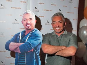 Cesar Millan poses with a cut out of Cesar Millan