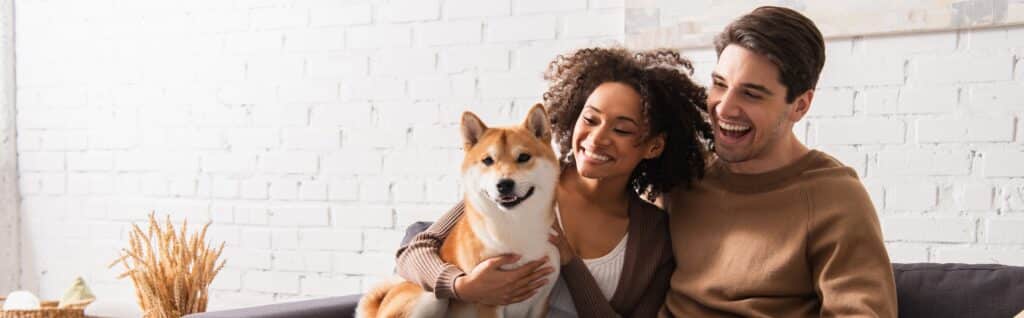 A couple welcomes a new dog into their home.