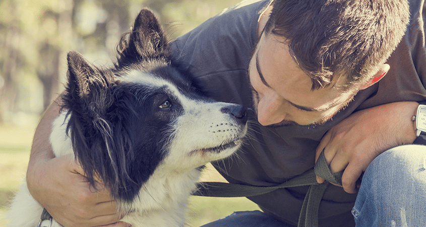 man takes a dog on a long walk. Taking the time to slow down
