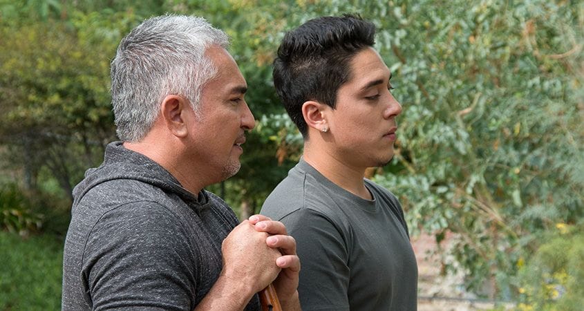 Cesar and his son Andrew talk to a group of people.