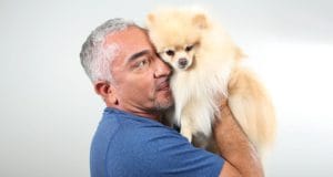 Cesar Millan hugs a cute dog