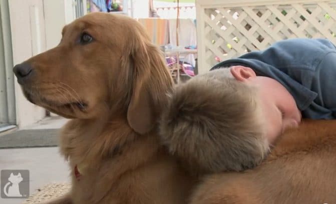 Autistic boy hugs his dog.